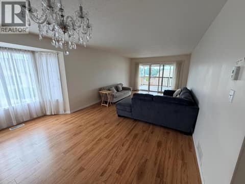 Living room and doors to balcony at 3930 20 Street Unit# 12, Harwood, Vernon