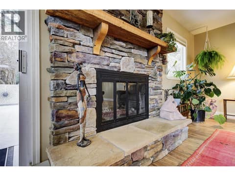 Enjoy cozying up to the wood fireplace at 391 Braeloch Road, Upper Mission, Kelowna