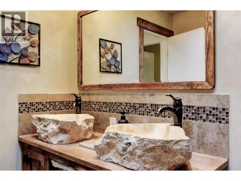 Indonesian stone sinks and wood vanity installed during 2016 bathroom reno at 391 Braeloch Road, Upper Mission, Kelowna