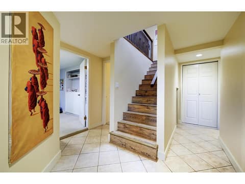 Lower level foyer. Stairs to main level renovated in 2018 at 391 Braeloch Road, Upper Mission, Kelowna