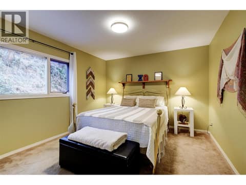 Main floor 2nd bedroom with window to back yard at 391 Braeloch Road, Upper Mission, Kelowna