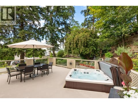 Side patio with hot tub and outdoor entertaining space at 391 Braeloch Road, Upper Mission, Kelowna