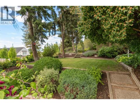 Upper yard features raised garden beds and easy care perennial plants at 391 Braeloch Road, Upper Mission, Kelowna