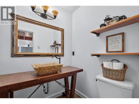 Main level powder room for guests at 10375 Westshore Road, Okanagan North, Vernon