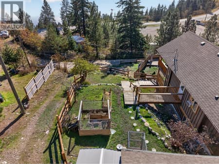 Yard to the side is perfect for the pets/gardening at 10375 Westshore Road, Okanagan North, Vernon