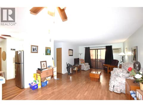 Sliders out to a closed in balcony off the living room at 3608 27 Avenue Unit# 301, City of Vernon