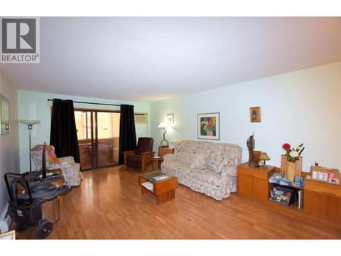 Spacious living room with easy care laminate flooring at 3608 27 Avenue Unit# 301, City of Vernon