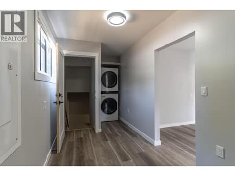 Large mudroom area with brand new laundry and access to the self contained unfinished basement at 2323 Vale Avenue, Lumby Valley