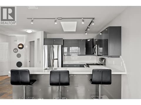 Kitchen | Main Level - Updated kitchen with quartz countertops, cabinetry, stainless steel appliances & flooring at 1525 Bear Creek Road Unit# 14, West Kelowna Estates