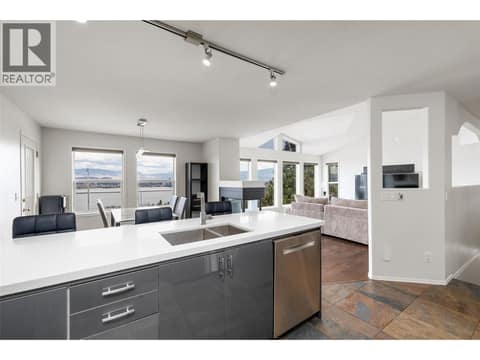 Kitchen | Main Level - Updated kitchen with quartz countertops, cabinetry, stainless steel appliances & flooring at 1525 Bear Creek Road Unit# 14, West Kelowna Estates