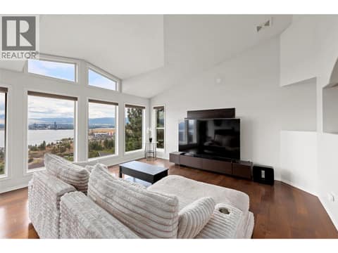 Living Room | Main Level - With incredible lake views, gas fire place, & updated flooring at 1525 Bear Creek Road Unit# 14, West Kelowna Estates