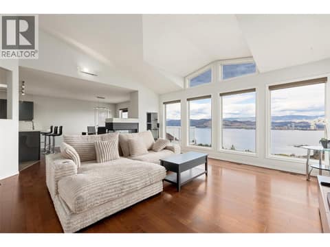 Living Room | Main Level - With incredible lake views, gas fire place, & updated flooring at 1525 Bear Creek Road Unit# 14, West Kelowna Estates