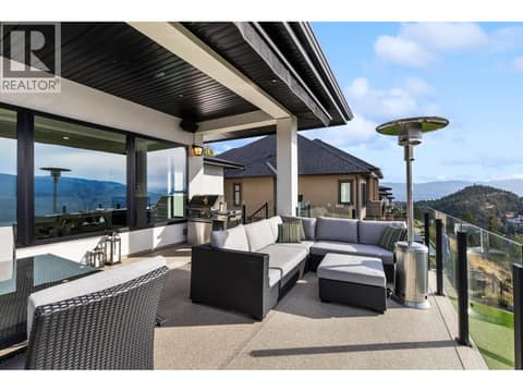 Deck has side stairs to lower yard at 1539 Rocky Point Drive, Wilden, Kelowna