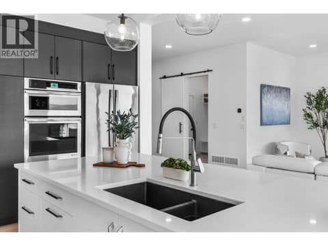 Induction cooktop and built-in oven/microwave at 1539 Rocky Point Drive, Wilden, Kelowna