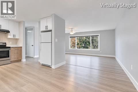 Dining Room looking into Kitchen and Living Room *Virtually Staged* at 465 - 467 Killarney Road, Rutland North, Kelowna