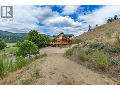 View of Log Home from the Firepit Area at 1225 Round Lake Road, Armstrong/ Spall.