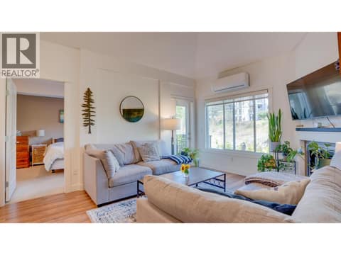 Living room and entry to primary bedroom at 3211 Centennial Drive Unit# 28, Alexis Park, Vernon