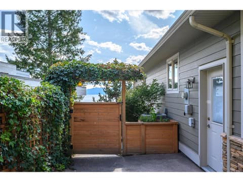 Exterior gate to walk down to backyard and dock/water at 100 Kestrel Place Unit# 11, Adventure Bay, Vernon