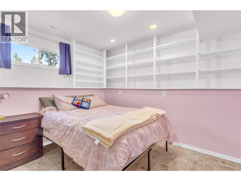 Fifth bedroom (lower level) with built-in shelving at 3227 McIver Road, Glenrosa, West Kelowna