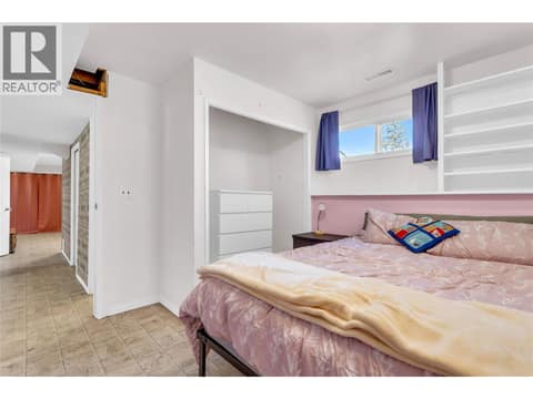 Fifth bedroom (lower level) with built-in shelving at 3227 McIver Road, Glenrosa, West Kelowna