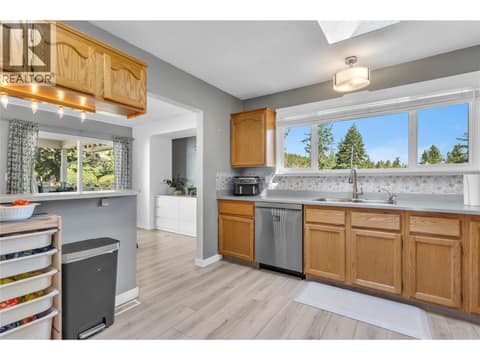Large window overlooking the backyard at 3227 McIver Road, Glenrosa, West Kelowna