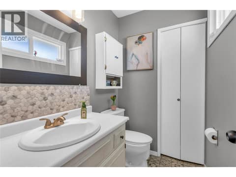 Linen closet in primary half bath at 3227 McIver Road, Glenrosa, West Kelowna