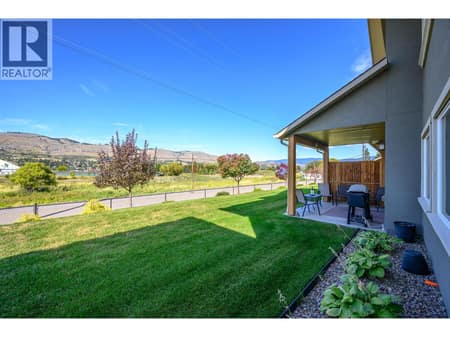 Lovely backyard area with covered deck and privacy fence between neighbours at 6600 Okanagan Avenue Unit# 38, Okanagan Landing, Vernon