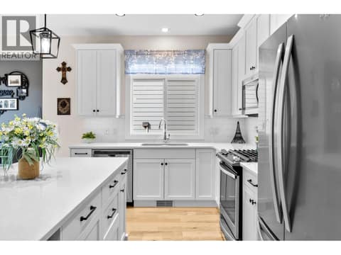Kitchen with quartz counters and gas stove at 13155 Staccato Drive, Lake Country North West