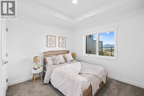 Bedroom. Photos are of a similar home; some features may vary at 1111 Frost Road Unit# 403, Upper Mission, Kelowna