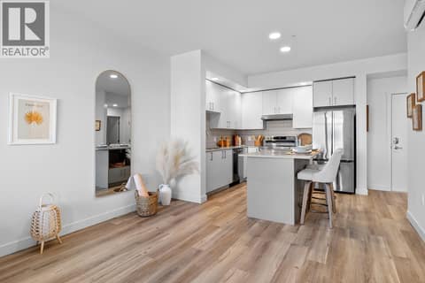 Kitchen and Living Room. Photos are of a similar home; some features may vary at 1111 Frost Road Unit# 403, Upper Mission, Kelowna