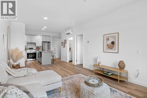 Living Room and Kitchen. Photos are of a similar home; some features may vary at 1111 Frost Road Unit# 403, Upper Mission, Kelowna