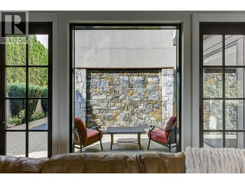 Huge picture window and glass doors to private courtyard and rock wall waterfall at 3673 Green Bay Landing, Lakeview Heights, West Kelowna