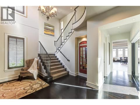 Soaring 18' ceilings and grand open stairway are sure to impress at 3673 Green Bay Landing, Lakeview Heights, West Kelowna