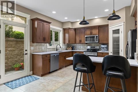 Kitchen equipped with updated quartz and new appliances. at 2283 Shannon Heights Court Unit# 6, Shannon Lake, West Kelowna