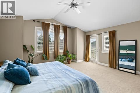 Primary bedroom with a private patio door and lots of daylight. at 2283 Shannon Heights Court Unit# 6, Shannon Lake, West Kelowna