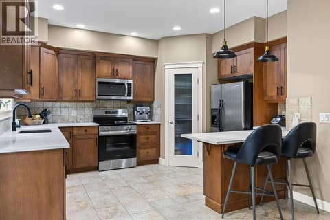 Spacious chef style kitchen with a walk in pantry and breakfast island! at 2283 Shannon Heights Court Unit# 6, Shannon Lake, West Kelowna