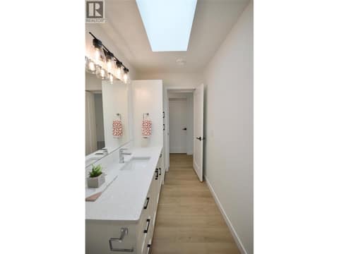 Main Bathroom with tile tub surround and quartz counters at 12204 Westside Road Unit# 200, Okanagan North, Vernon
