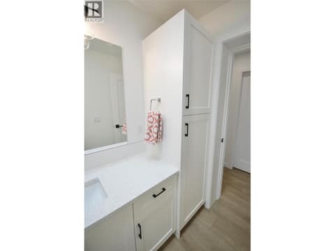 Main Bathroom with tile tub surround and quartz counters at 12204 Westside Road Unit# 200, Okanagan North, Vernon