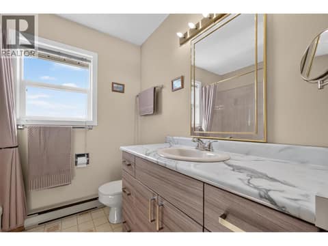 Full upper-level bathroom with a spacious vanity and natural light at 3040 Seclusion Bay Road, Westbank Centre, West Kelowna