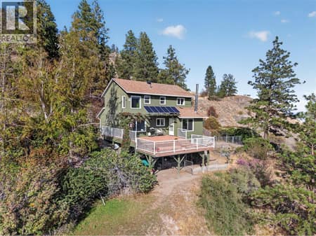 Perched above Okanagan Lake on 1.77 private acres, surrounded by nature and panoramic lake and mountain views at 3040 Seclusion Bay Road, Westbank Centre, West Kelowna