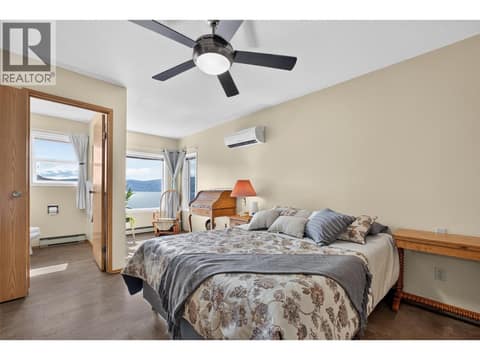 Spacious primary bedroom with beautiful lake views and a 2-piece ensuite at 3040 Seclusion Bay Road, Westbank Centre, West Kelowna