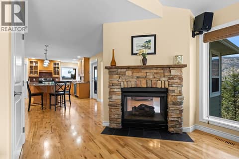 Fireplace doubles through living room and kitchen - get the stockings hung! at 2620 Arthur Road, McKinley Landing, Kelowna