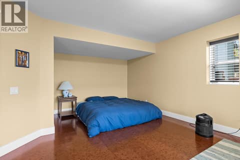Lower level primary sized bedroom easily made into a home gym, office or hobby room! at 2620 Arthur Road, McKinley Landing, Kelowna