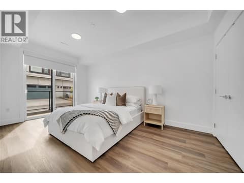 Lower level bedroom with access to the lower deck at 2100 Campbell Place Unit# 154, Lakeview Heights, West Kelowna