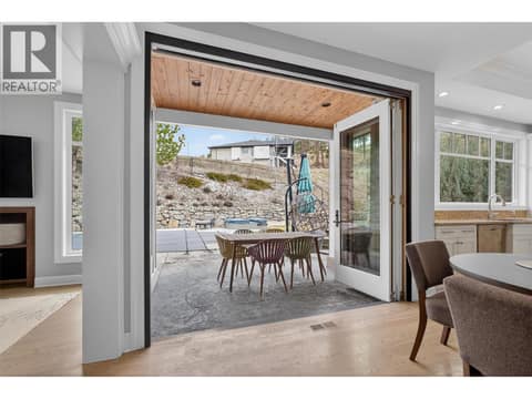 Bi-folding patio doors for effortless connection to the yard at 1996 Twin Ridge Court, Wilden, Kelowna