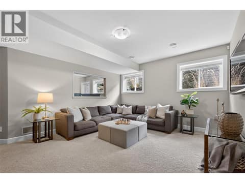 Recreation/family room with a wet bar to the left on the lower level at 1996 Twin Ridge Court, Wilden, Kelowna