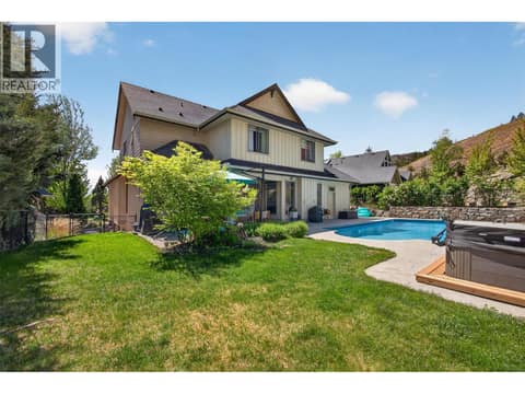 With plenty of grass space, an in-ground pool & hot tub at 1996 Twin Ridge Court, Wilden, Kelowna