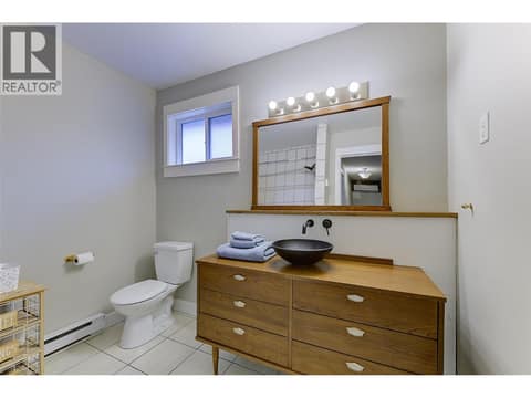 Main 4 piece bathroom up with funky dresser vanity at 1859-1861 Mountain Avenue, Glenmore, Kelowna