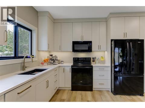 Upscale kitchen, quartz counters, brushed gold fixturing at 1859-1861 Mountain Avenue, Glenmore, Kelowna