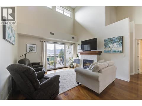 Great room with fireplace and 18' ceilings at 2142 Vasile Road Unit# #409, Springfield/Spall, Kelowna